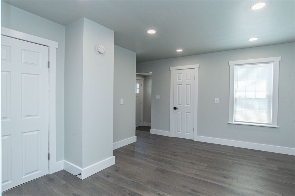 260 High Street Cumberland, RI 02864 - Photo 8 of 42 an empty room with wooden floor and windows