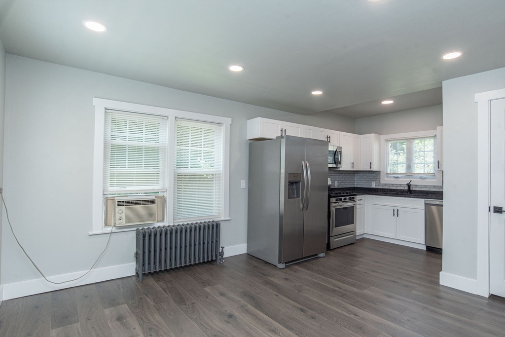 260 High Street Cumberland, RI 02864 - Photo 9 of 42 a kitchen with stainless steel appliances a refrigerator and wooden floor