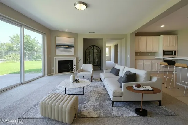 a view of kitchen with kitchen island wooden floor appliances and cabinets