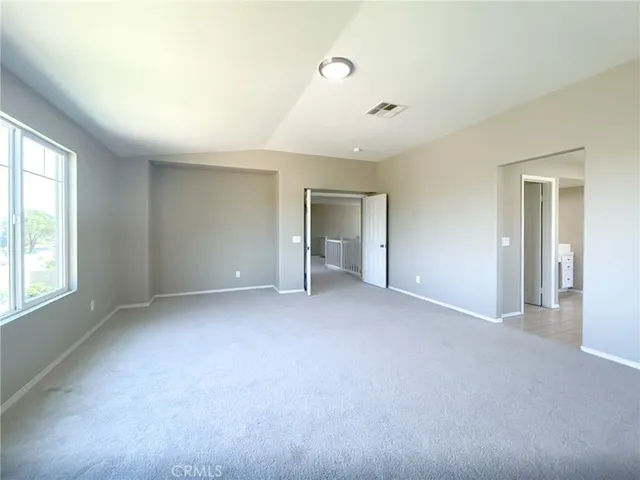 a large white bathroom with a granite countertop sink a mirror and a bathtub