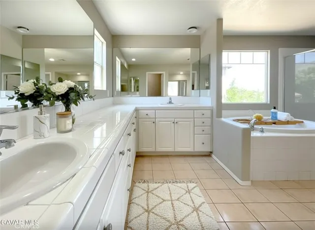 a spacious bedroom with a bed and a chandelier
