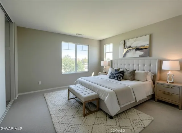 a bedroom with a bed and a lamp