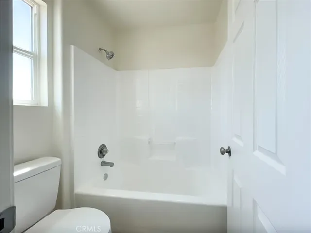 a view of an empty room and closet area