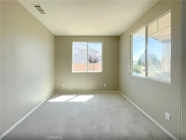 a bathroom with a sink a toilet and a window
