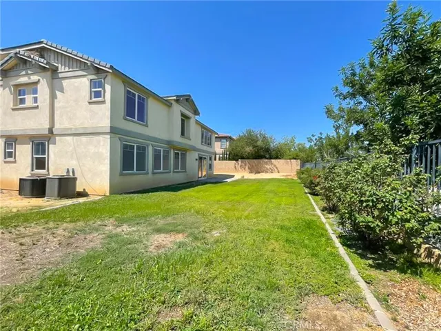 a view of backyard with a swimming pool