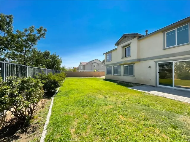 a view of backyard with a swimming pool