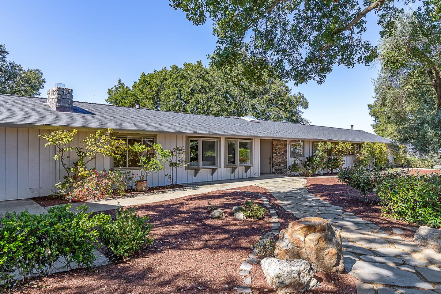 a view of a house with garden and porch