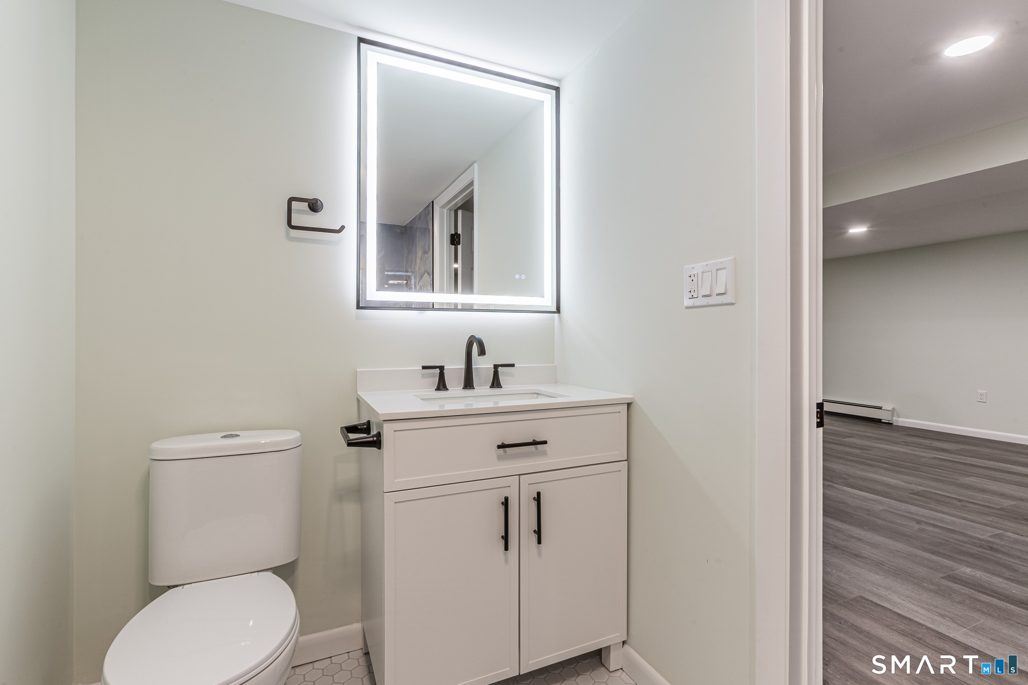 26 Kelly Road Hamden, CT 06518 - Photo 24 of 37 a bathroom with a toilet sink vanity and mirror