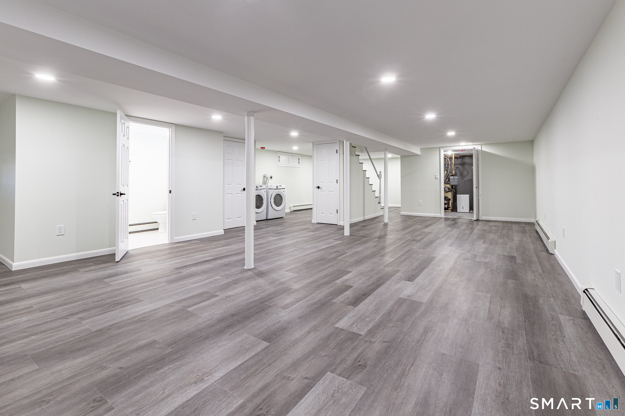26 Kelly Road Hamden, CT 06518 - Photo 25 of 37 a view of a big room with wooden floor and windows