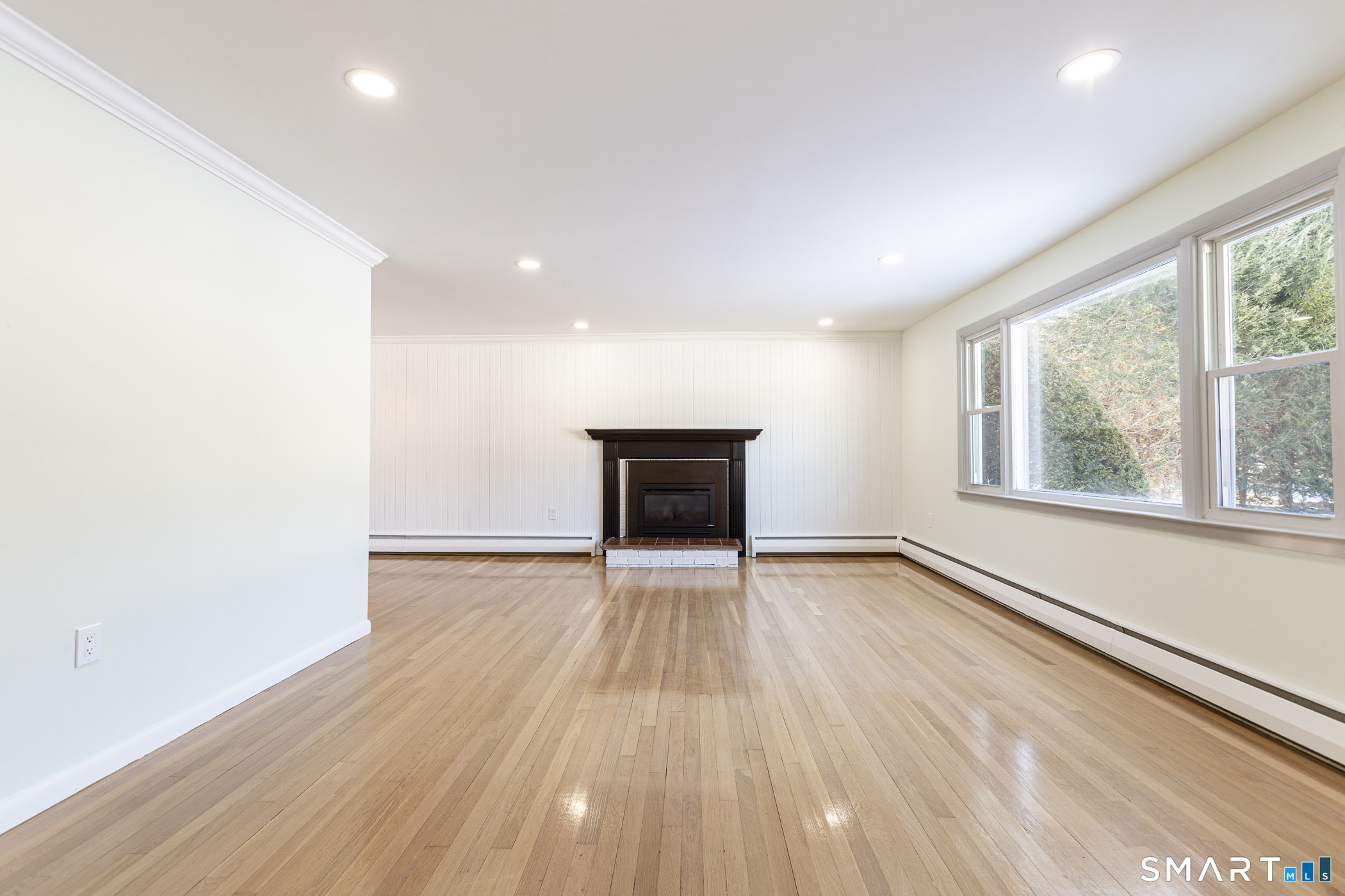 26 Kelly Road Hamden, CT 06518 - Photo 7 of 37 an empty room with wooden floor and windows