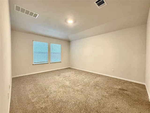an empty room with a empty space and windows