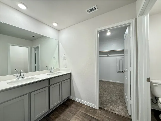 a bathroom with a double vanity sink mirror and shower
