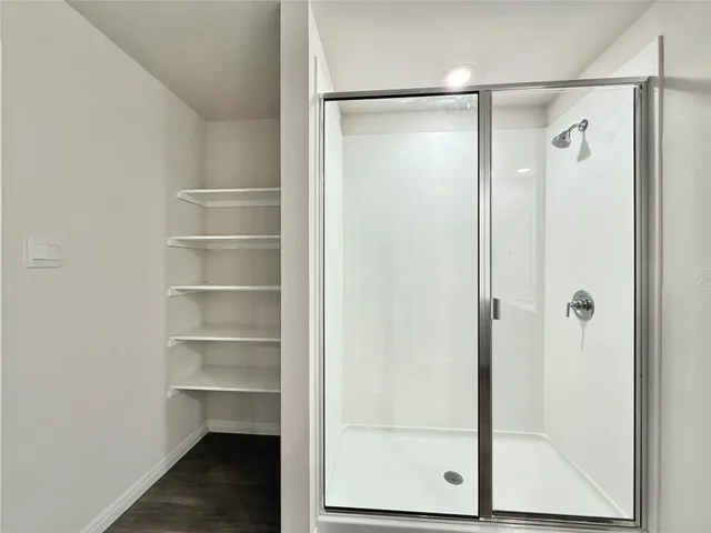 a bathroom with a glass shower door