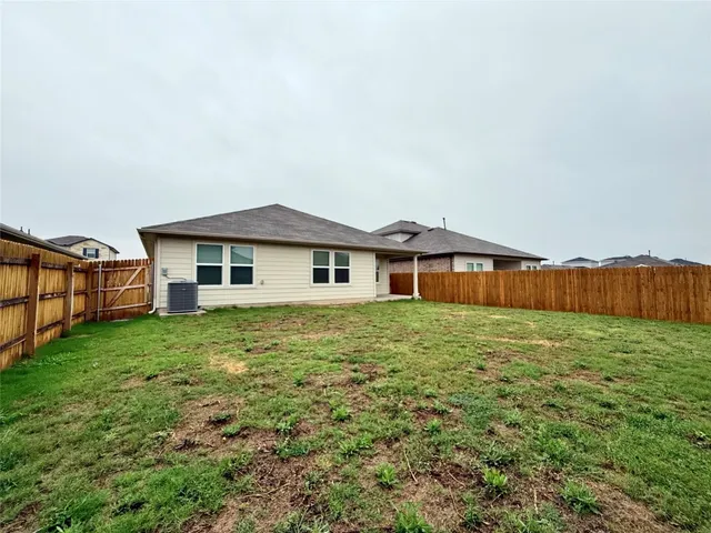 a house with huge green field in front of it