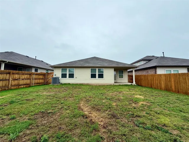 a view of a yard in front of a house with large trees
