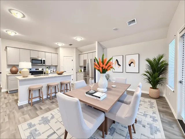 a living room with kitchen island furniture and a kitchen view