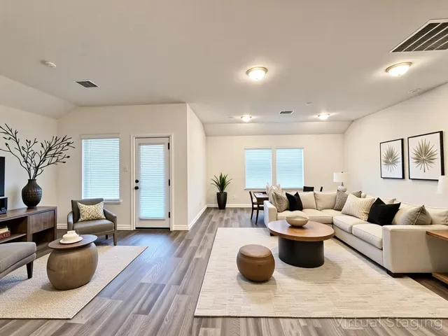 a living room with lots of furniture and view of kitchen