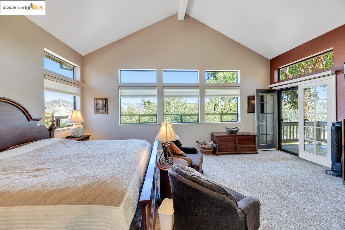 13700 Clements Road Groveland, CA 95321 - Photo 29 of 93 Carpeted bedroom featuring beam ceiling, high vaulted ceiling, and access to exterior