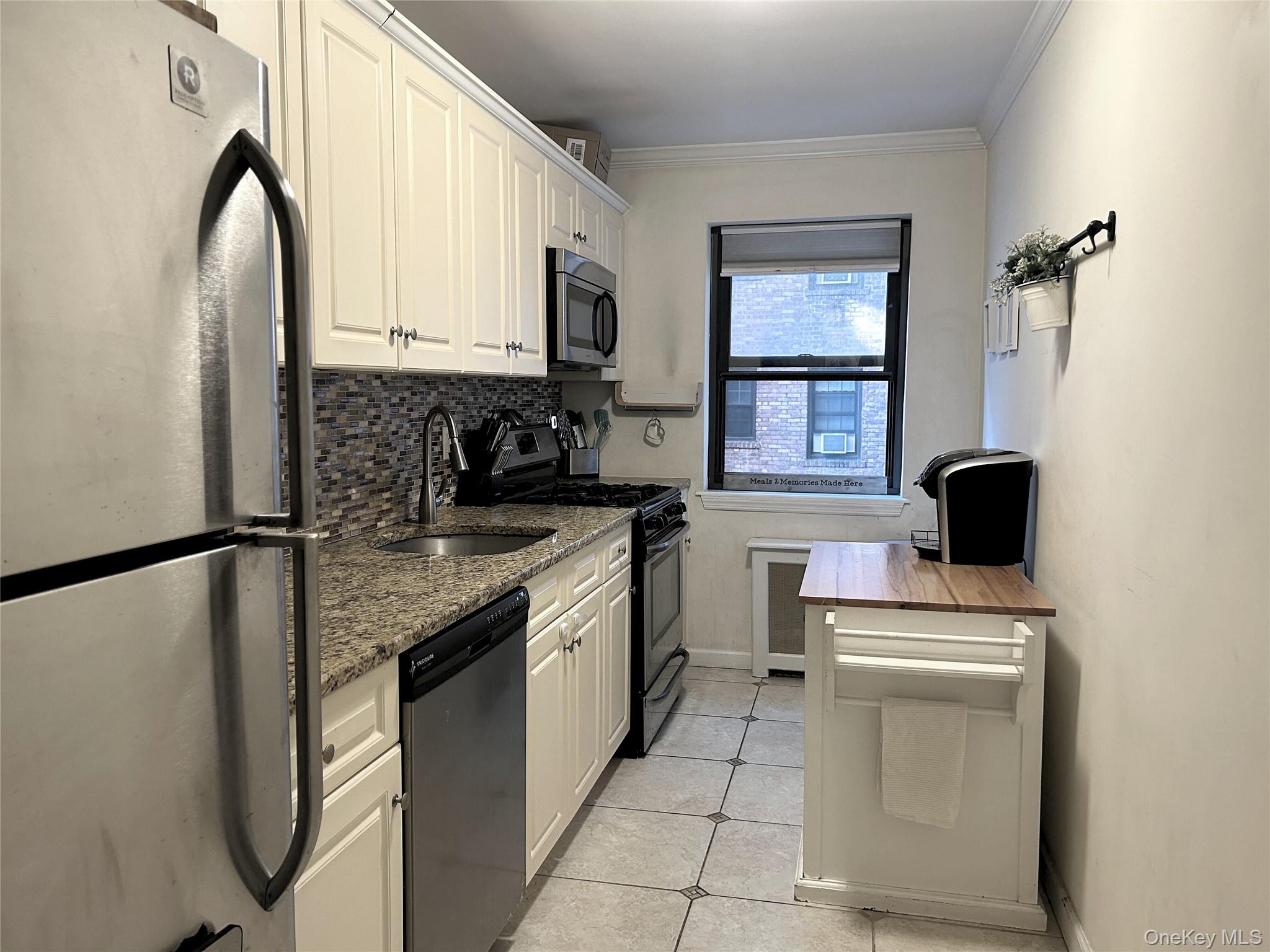 19 Old Mamaroneck Road, Unit 2J White Plains, NY 10605 - Photo 4 of 14 a kitchen with a refrigerator sink and cabinets