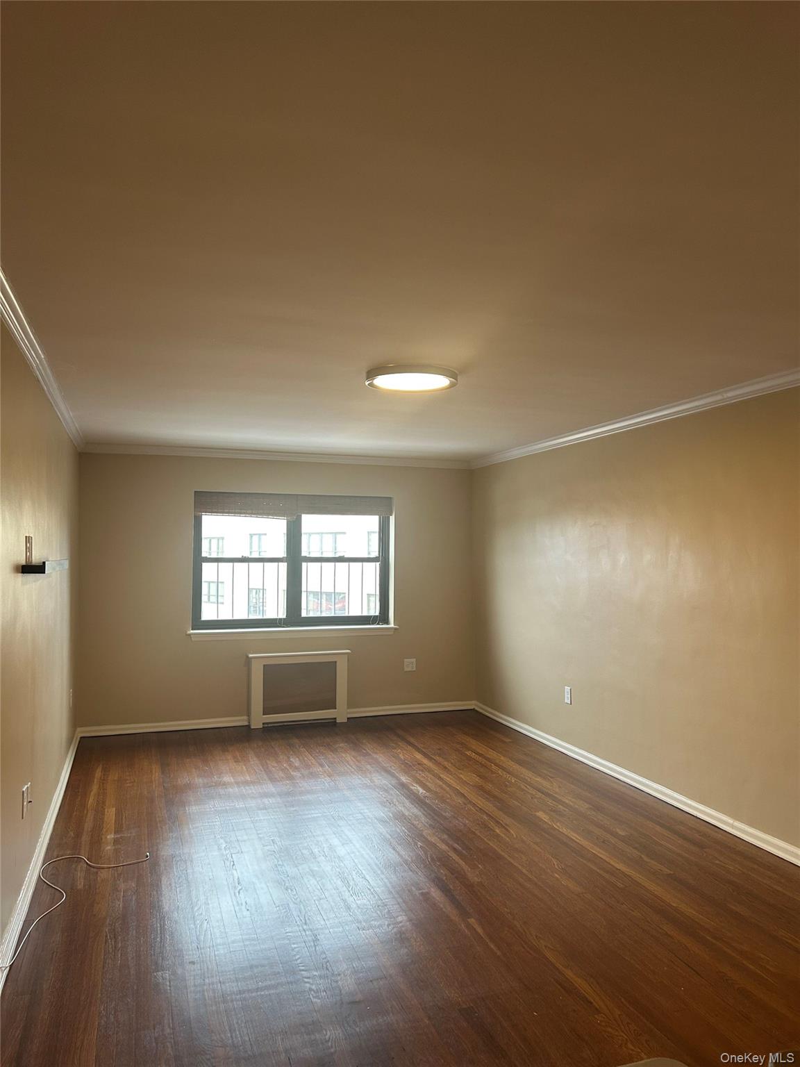 19 Old Mamaroneck Road, Unit 2J White Plains, NY 10605 - Photo 6 of 14 an empty room with wooden floor and windows