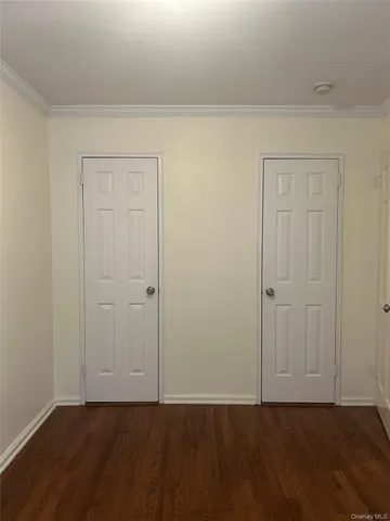 a view of an empty room and wooden floor