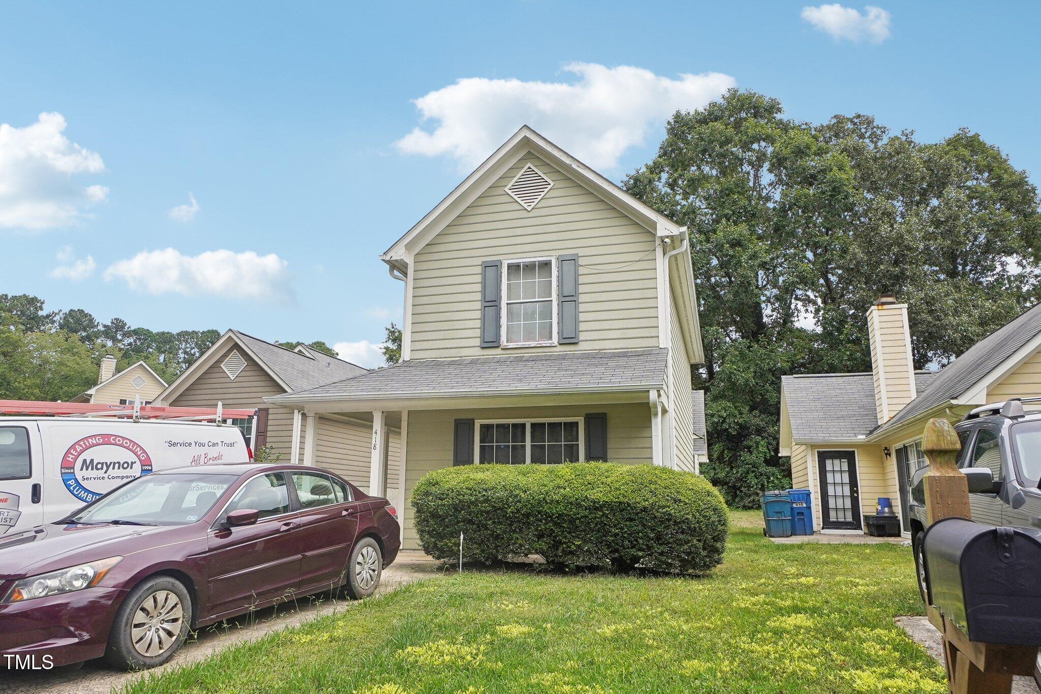 a front view of a house with a garden