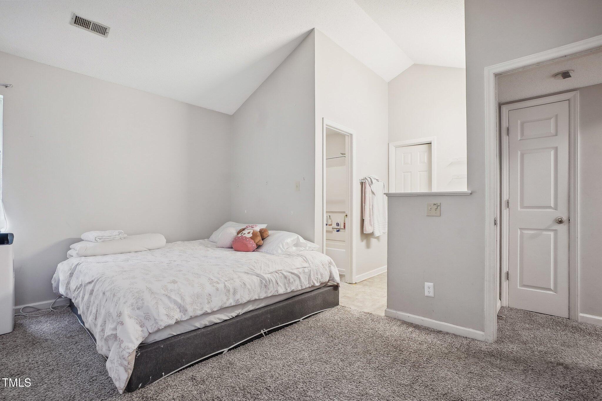 418 Devlin Place Durham, NC 27707 - Photo 12 of 19 a bedroom with a bed and cabinets