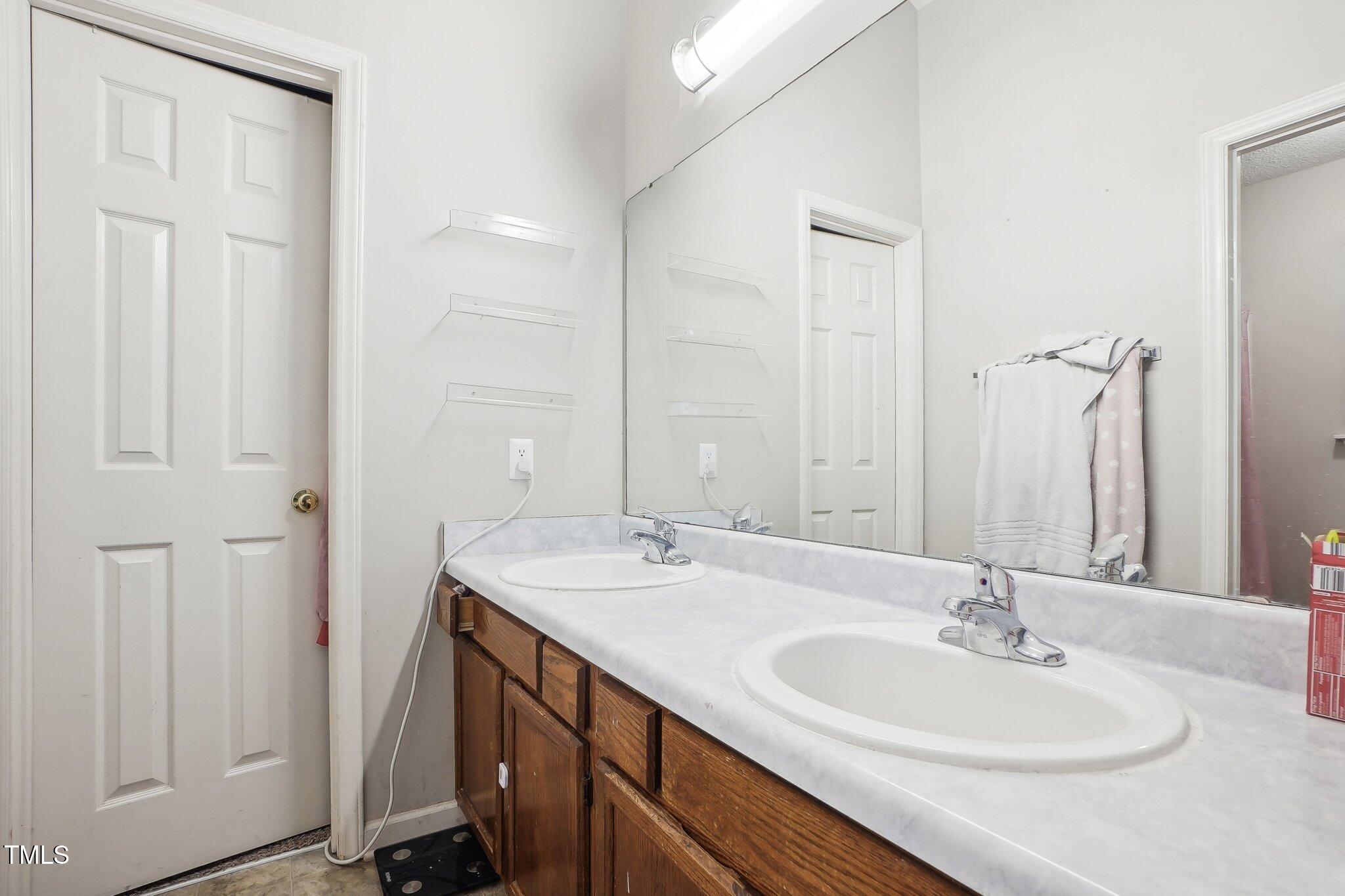 418 Devlin Place Durham, NC 27707 - Photo 13 of 19 a bathroom with 2 sink and a mirror