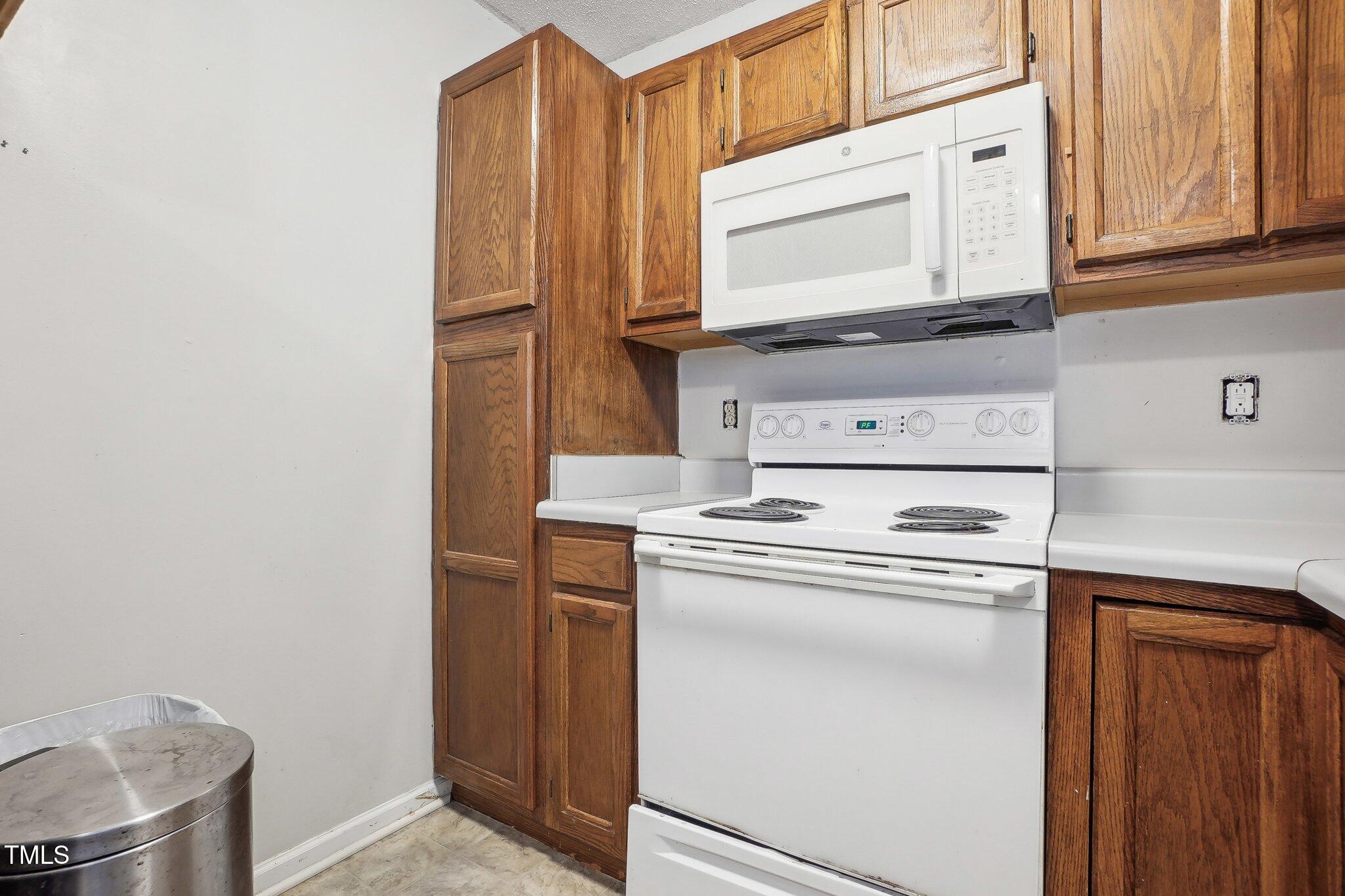 418 Devlin Place Durham, NC 27707 - Photo 15 of 19 a kitchen with granite countertop cabinets stainless steel appliances and a counter space