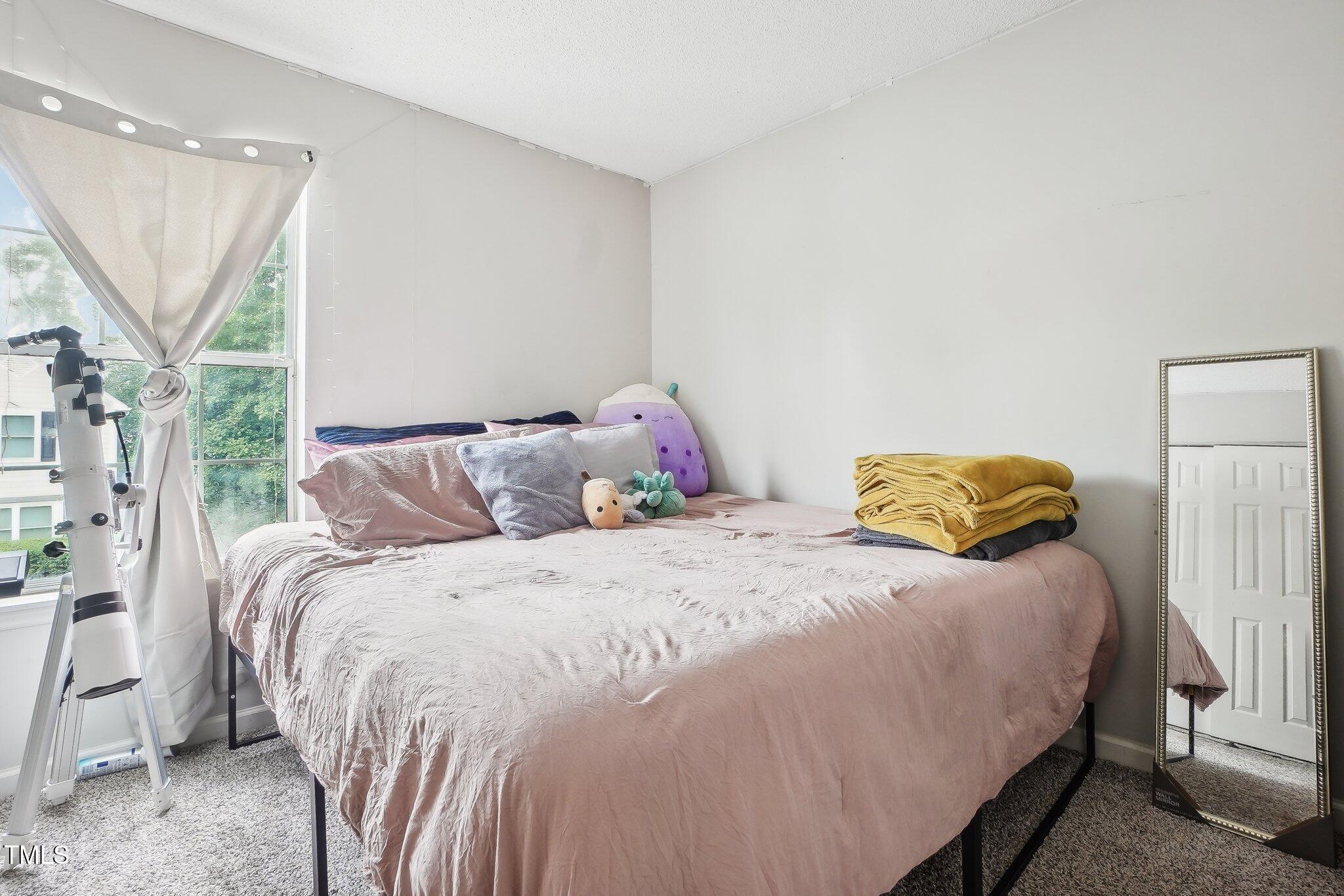 418 Devlin Place Durham, NC 27707 - Photo 16 of 19 a bedroom with a bed and wooden floor