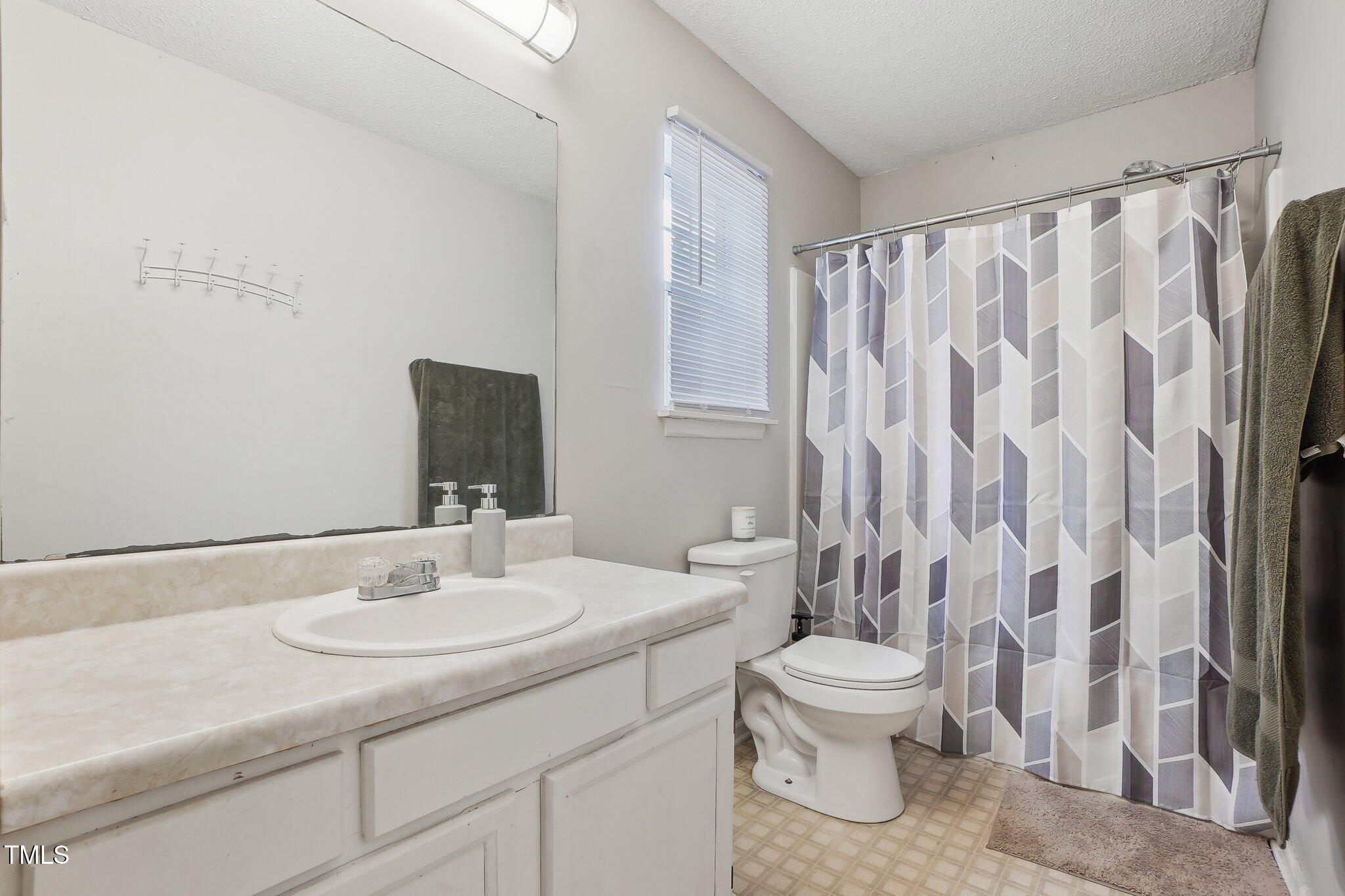 418 Devlin Place Durham, NC 27707 - Photo 18 of 19 a bathroom with a sink toilet and shower