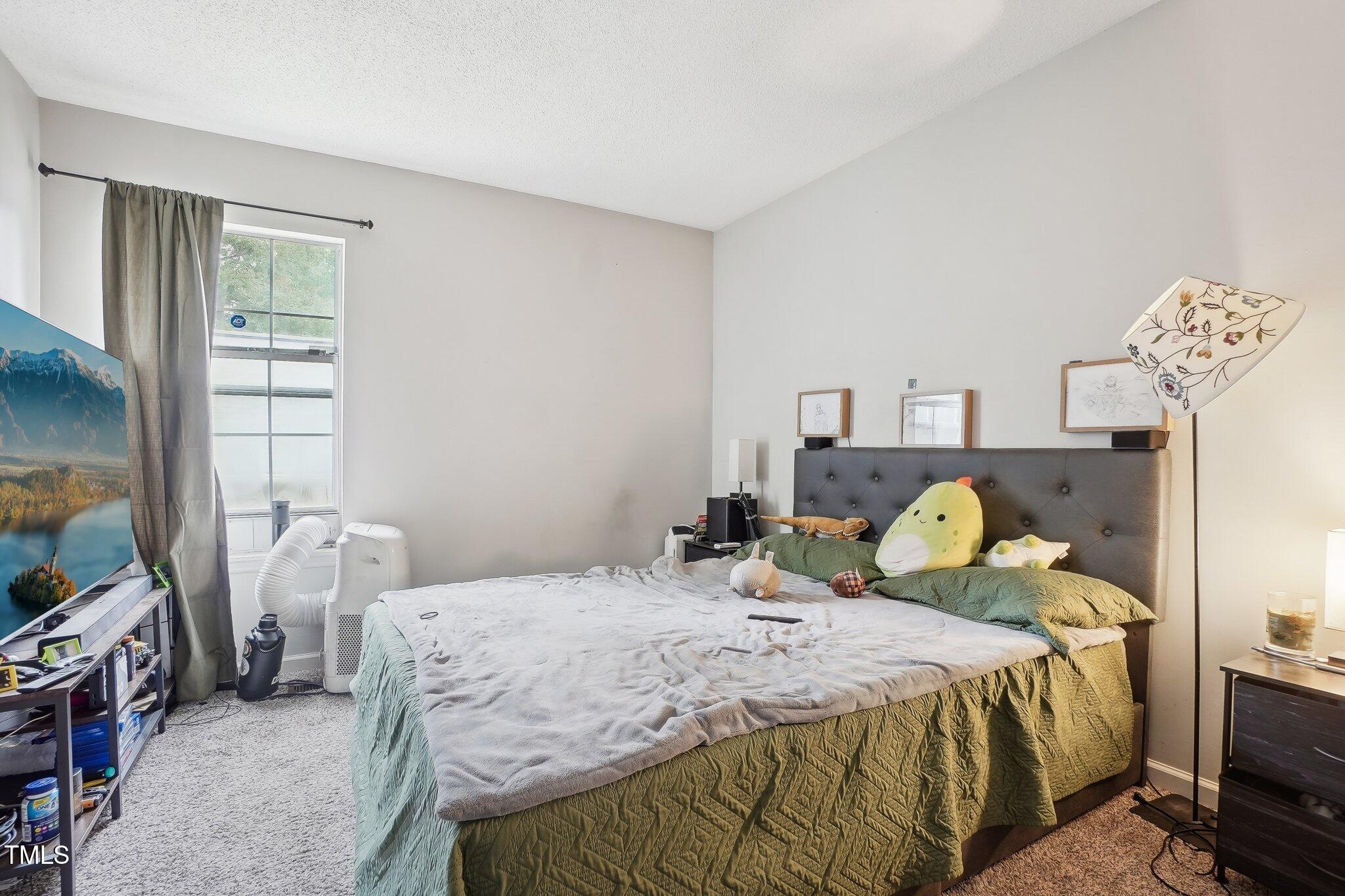 418 Devlin Place Durham, NC 27707 - Photo 19 of 19 a bedroom with a bed and wooden floor