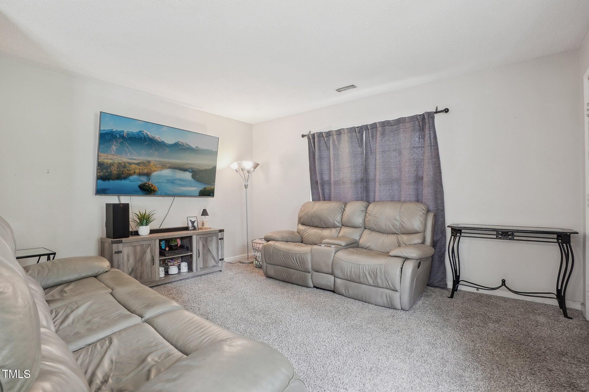 418 Devlin Place Durham, NC 27707 - Photo 3 of 19 a living room with furniture and a flat screen tv