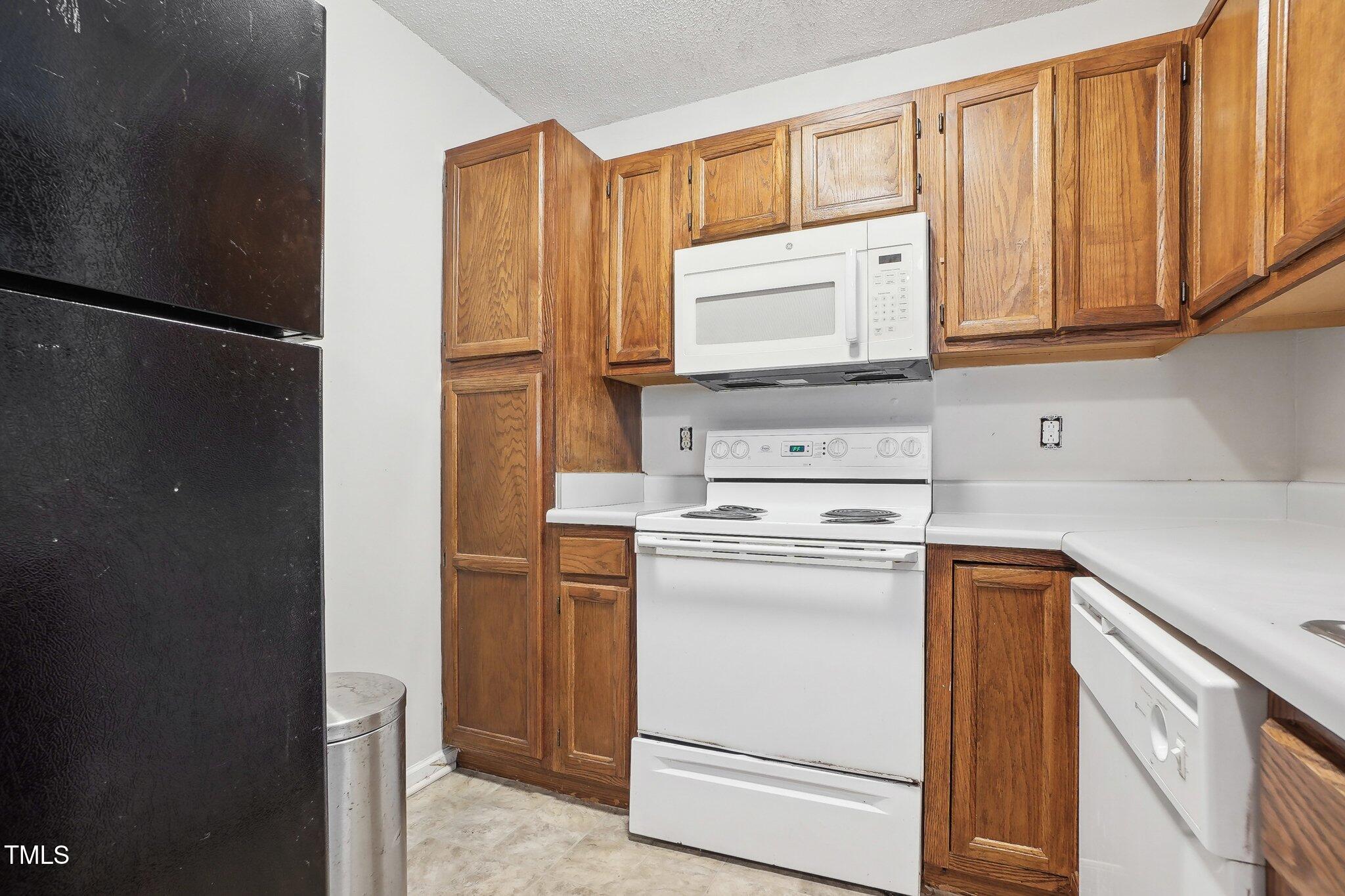 418 Devlin Place Durham, NC 27707 - Photo 9 of 19 a kitchen with a refrigerator sink and cabinets