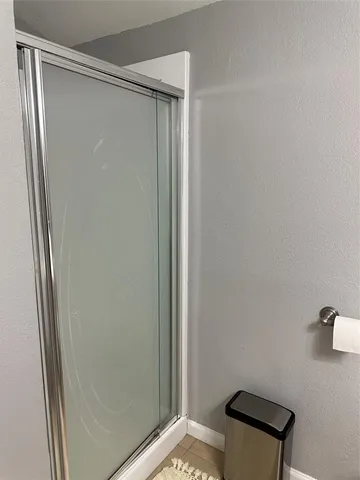 a bathroom with a shower and a mirror