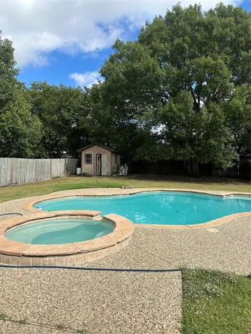 a view of swimming pool with a yard