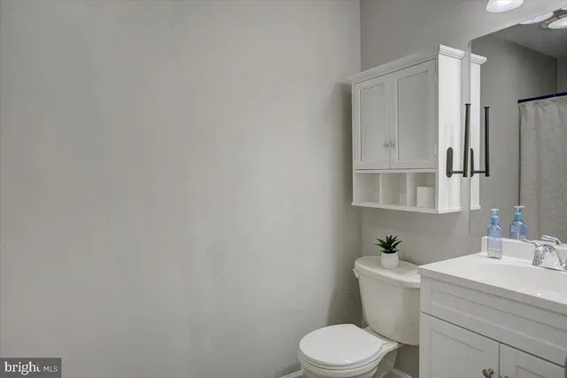 a white toilet sitting next to a bathroom sink