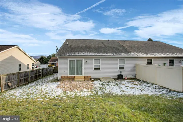 a view of a house with a backyard