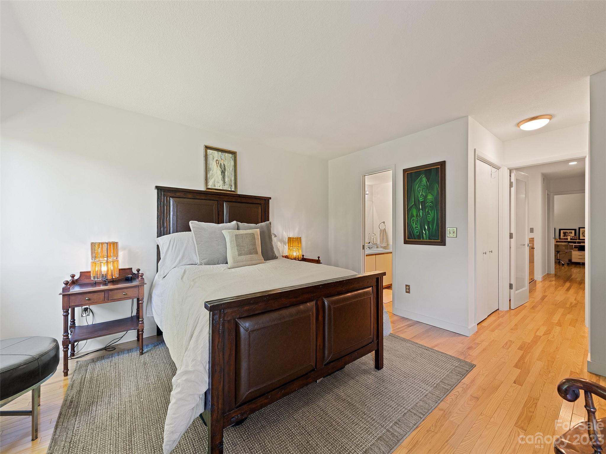 87 Willow Road, Unit C1 Waynesville, NC 28786 - Photo 15 of 48 a bed room with a bed and a chandelier