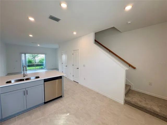 a view of cabinets a sink and dishwasher in a room