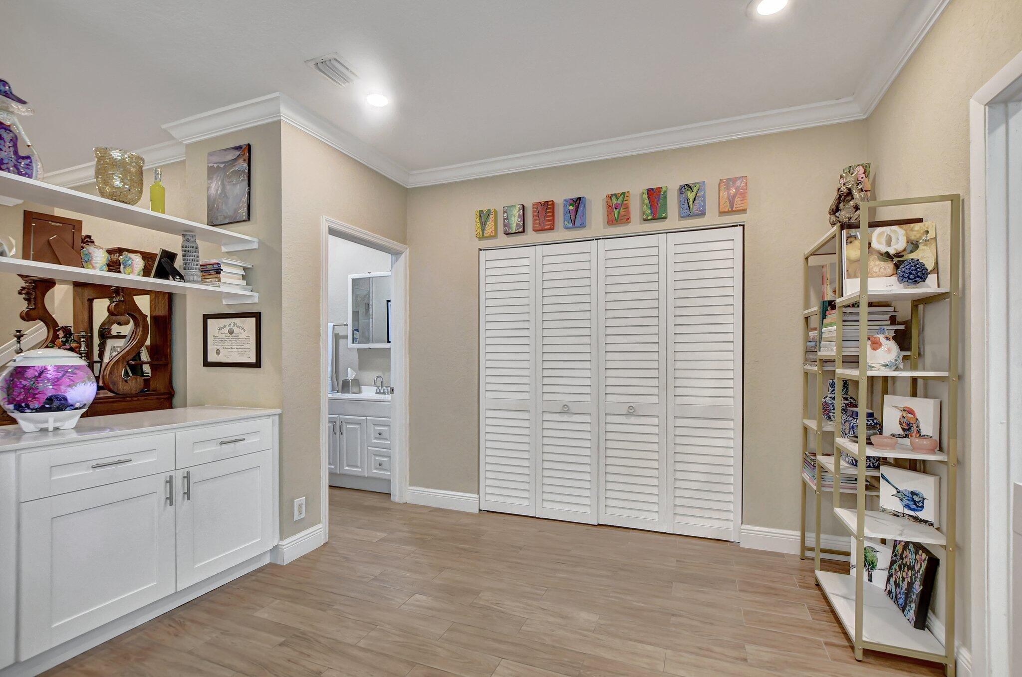 6682 Via Regina Boca Raton, FL 33433 - Photo 31 of 46 a view of an entryway with wooden cabinet