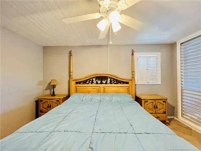 a large bedroom with a bed and a chandelier
