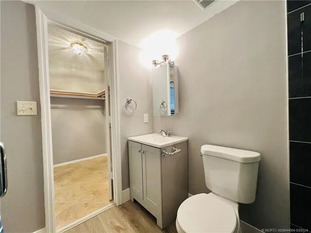 a white toilet sitting next to a bathroom sink