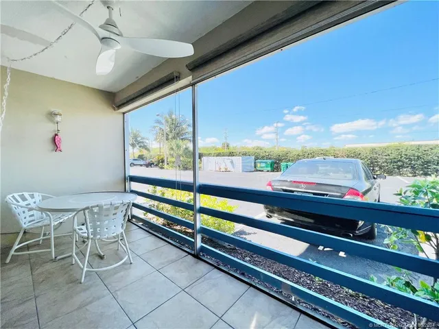 a view of a chairs and table in a balcony