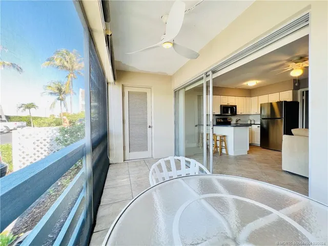 a large white kitchen with a large window