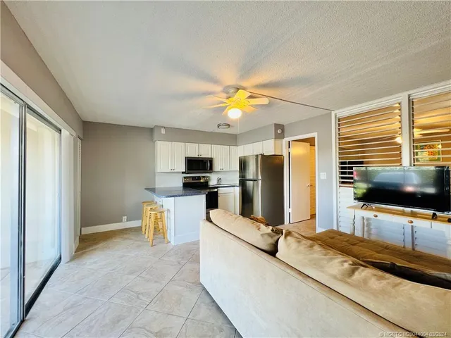 a kitchen with a refrigerator a stove top oven a sink dishwasher and wooden cabinets