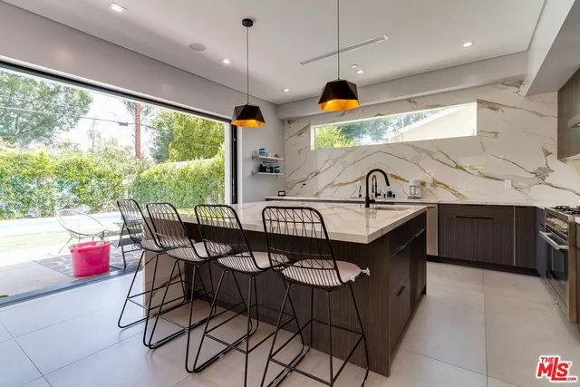 a kitchen with stainless steel appliances granite countertop a stove and a large kitchen island