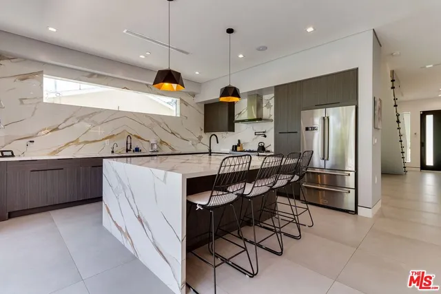 a kitchen with stainless steel appliances kitchen island a large island in the center