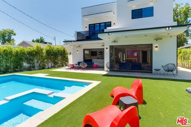 a living room with furniture and dining table