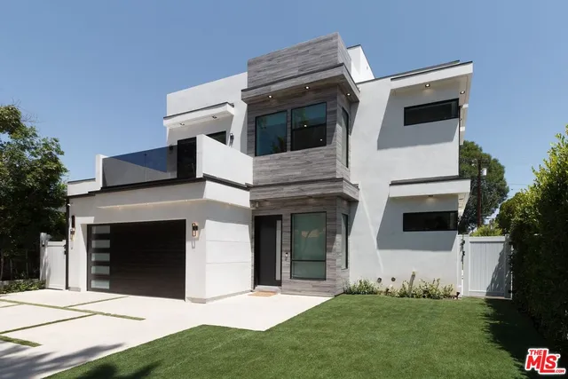 a view of a patio with a table chairs and a yard
